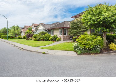 Custom Built Luxury Homes With Nicely Trimmed And Designed Front Yard, Lawn In A Residential Neighbourhood In Canada. Street Of Houses.