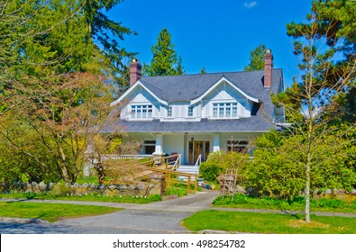 Custom Built Luxury House  With Nicely Trimmed And Landscaped Front Yard, Lawn And With Wheelchair Ramp For Disabled People In  Residential Neighborhood. Vancouver Canada.