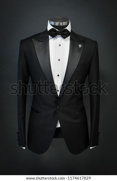 Custom expensive tailored suit, tuxedo on\
mannequin, isolated on background\
