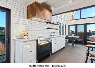 Custom Kitchen With Floor To Ceiling Windows, Copper Accents, And Subway Tile