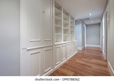 Custom Made Lacquered Wood Bookcase In Home Corridor With Dark Wood Floor