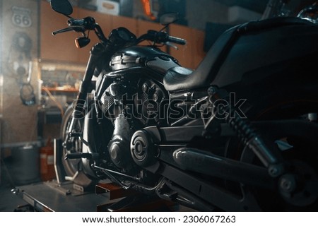 Custom motorcycle in authentic creative workshop with flare light visual effects