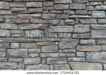 Custom stone wall on side of building