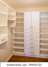 Custom White Wood Cabinetry In A Walk In Closet
