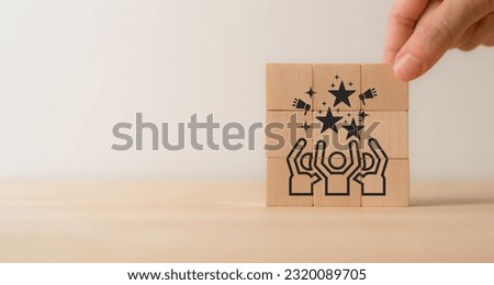 Customer advocacy and loyalty concept. Loyal customers sharing their experiences with your business and help other customers get the most value out. Wooden cube blocks with advocacy and loyalty icon.