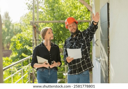 customer architect and builder contractor at construction site discuss calculate plan inspect
