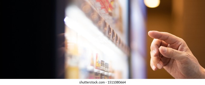 A customer buying beverage at a vending machine