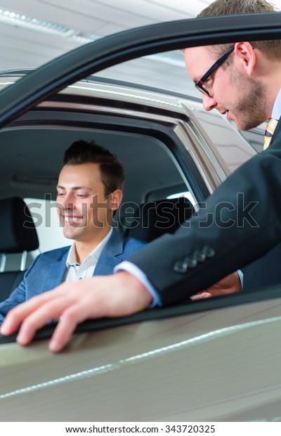 Customer buying new\
car in auto dealership\
