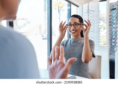 A Customer Buying, Testing Or Trying On Glasses At An Optometrist Store Or Shop. Health Care Eye Wear Professional Picking Or Selling A Pair Of New Eyeglasses To A Young Female Client Or Patient.