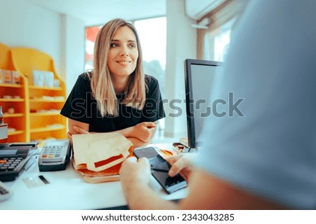 
Customer Checking out in a Store Using Electronic Payment 
Cheerful client paying in a grocery store 
