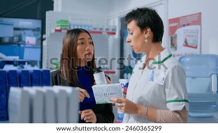 Customer in chemist store asking pharmacist for medical opinion, needing treatment for headache. Certified druggist helping client choose best pharmaceutical cure for her illness