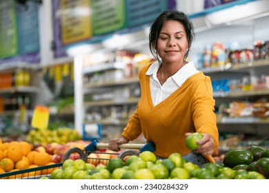 Customer chooses lemon in a neighborhood store - Powered by Shutterstock