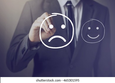 Customer choosing to write unhappy face on virtual screen over happy face
