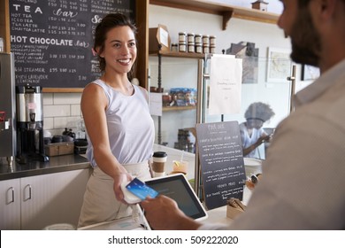 Customer At Coffee Shop Pays Smiling Waitress With Card