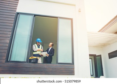 Customer And Constructor Foreman Worker With Helmet And Vest Shake Hand In New House Building In Real State Business And Housing Industry Concept