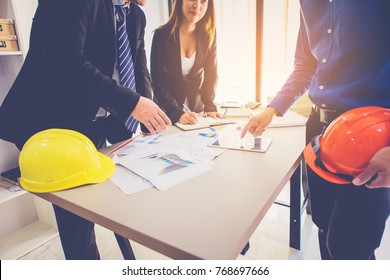 Customer And Constructor Foreman Worker With Helmet And Vest Looking Blueprints In New House Building In Real State Business And Housing Industry Concept.