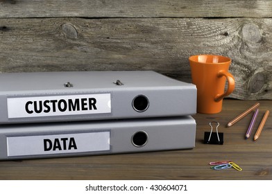 Customer Data - Two Folders On Wooden Office Desk