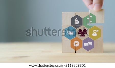 Customer engagement concept.
Technology, internet, business and marketing. Marketing campaign and communication to target customer. Hand  puts wooden cubes with online offline channel for engagement.
