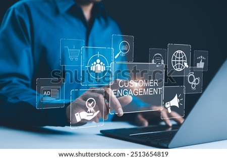 Customer engagement and digital marketing concept. Businessman interacting with virtual icons representing customer engagement, digital marketing, online shopping, and client services using a laptop.