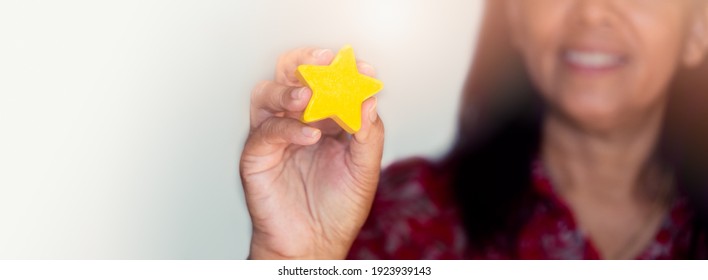 Customer Experience Concept, Best Excellent Services for Satisfaction present by Hand of Client giving a Star Rating.Woman Giving Star Feedback.Clients Choosing Satisfaction Rating.Customer Service. - Shutterstock ID 1923939143