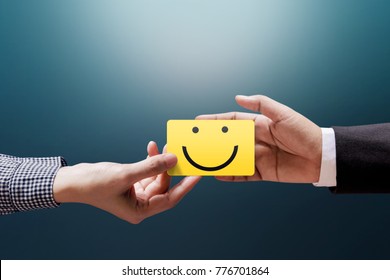 Customer Experience Concept, Happy Client Woman Giving A Feedback With Happy Smiley Face Card Into A Hand Of Businessman