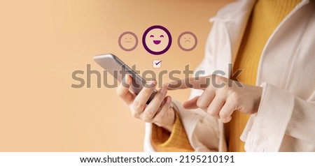 Customer Experience Concept. Happy Client Using Smartphone to Submit Rating for Online Satisfaction Surveys. Positive Review Feedback on Mobile Phone