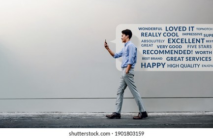 Customer Experience Concept. Reading Positive Online Review via Smartphone. Smiling Young Businessman Using Mobile Phone while Walking by the Urban Building Wall. Side View. Full Length