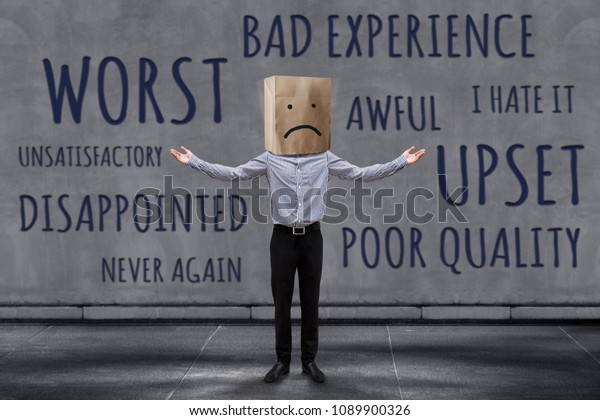 Customer Experience Concept,\
Unhappy Businessman Client with Sadness Emotion Face on Paper Bag,\
Blurred Concrete Wall with Wording of Negative Reviews as\
background