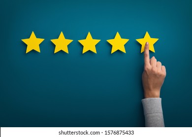 Customer Experience Concept. Woman hand showing on five star excellent rating on background, copy space - Shutterstock ID 1576875433