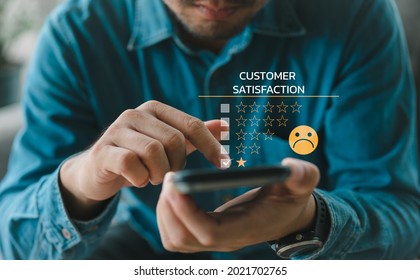 Customer Experience dissatisfied Concept, Unhappy Businessman Client with Sadness Emotion Face on smartphone screen, Bad review, bad service dislike bad quality, low rating, social media not good. - Shutterstock ID 2021702765