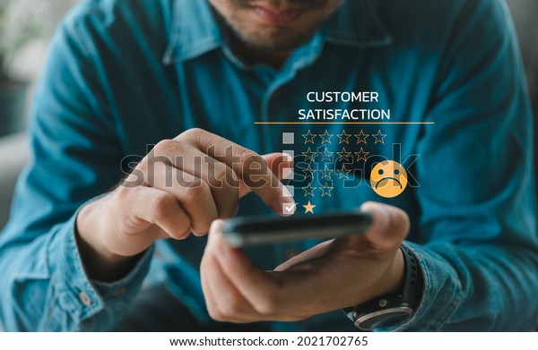 Customer Experience dissatisfied Concept, Unhappy\
Businessman Client with Sadness Emotion Face on smartphone screen,\
Bad review, bad service dislike bad quality, low rating, social\
media not good.