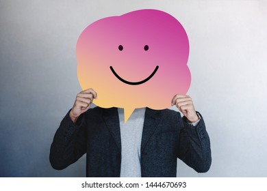 Customer Experience or Human Emotional Concept. Man Presenting his Happy Feeling by Drawn Line Cartoon Face on Speech Bubble Card - Shutterstock ID 1444670693