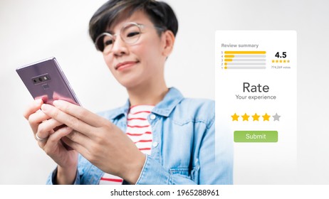 Customer Experience Ratings Concept. An Asian Woman Using A Smartphone To Submit Stars Feedback, And Review To Products Or Services She Quite Satisfied. Marketing Business Important Tools. Surveys.