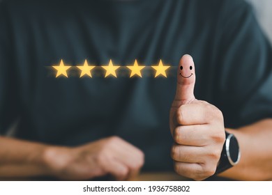Customer experience satisfaction concept. customer hand with thumb up Positive emotion smiley face icon and five star with copy space. Best Excellent Services Rating for Satisfaction.