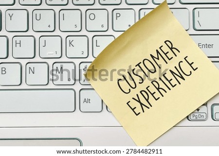 Customer experience sticky note on keyboard for business communication concept.