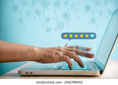 Customer Experiences Concept. Happy Client Using Computer Laptop To Giving Best Excellent Review Rating For Online Satisfaction Surveys. Positive Feedback On Mobile Phone