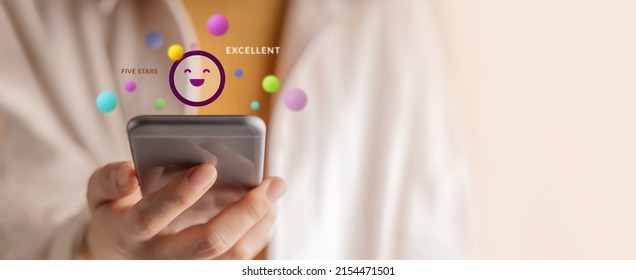 Customer Experiences Concept. Happy Client Using Smartphone to Reading Review Rating for Online Satisfaction Surveys. Positive Feedback on Mobile Phone - Shutterstock ID 2154471501