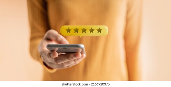 Customer Experiences Concept. Happy Client Using Smartphone To Submit Five Star Review Rating For Online Satisfaction Surveys. Positive Feedback On Mobile Phone