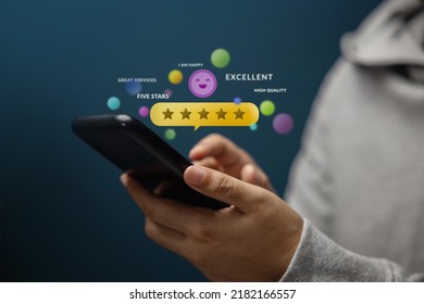 Customer Experiences Concept. Happy Client Using Smartphone to Review Five Star Rating for Online Satisfaction Surveys. Positive Feedback on Mobile Phone