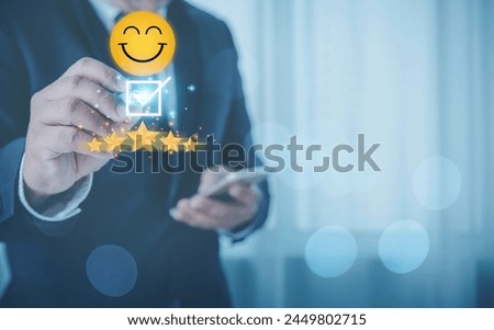Customer feedback evaluation and satisfaction concept. Businessman touching to five golden stars with smile face icon to the best feedback after use get service.