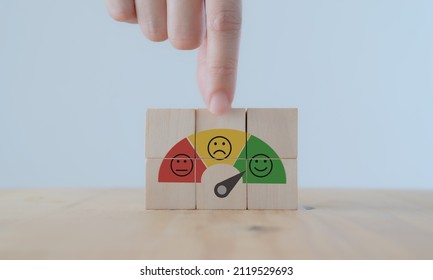 Customer feedback, service rating, satisfaction, customer experience concept. Evaluation for improvement product and service. Hand puts wooden cubes with emotions satisfaction meter icons. - Shutterstock ID 2119529693
