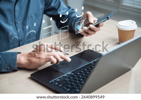 Customer feedback survey. Customer evaluation experience. Feedback survey. A man is using a laptop and a cell phone. The laptop screen shows a smiley face and the cell phone screen shows a thumbs up.