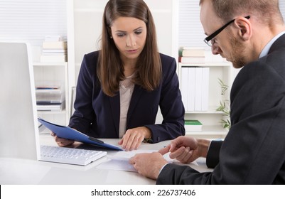 Customer and female financial agent in a discussion at desk. - Powered by Shutterstock