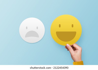 Customer giving smile emoticon for rating on blue background. Service rating, feedback, satisfaction concept