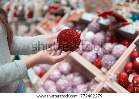 customer hands choosing Christmas tree decoration balls. difficult decision. Various choice
