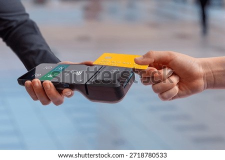 Customer inserts payment card into mobile POS terminal, illustrating checkout process, retail transaction, and modern cashless card payment experience