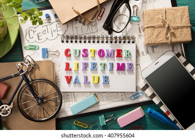 Customer Lifetime Value - Inscription And Office Supplies On The Desk 