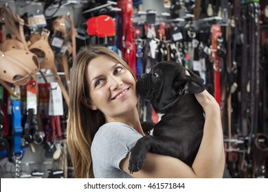 Customer Looking Away While Carrying French Bulldog In Store