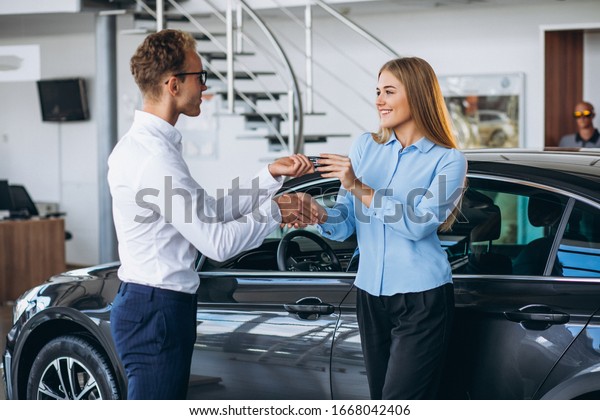 Customer making a\
purchase in a car\
showroom