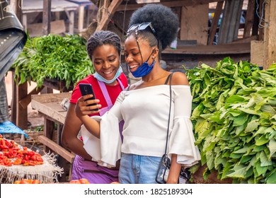 Customer In A Market Showing A Trader Something Exciting On Her Phone